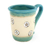 Coastal themed stoneware mug in Caribbean Blue with hand carved sand dollar design. 