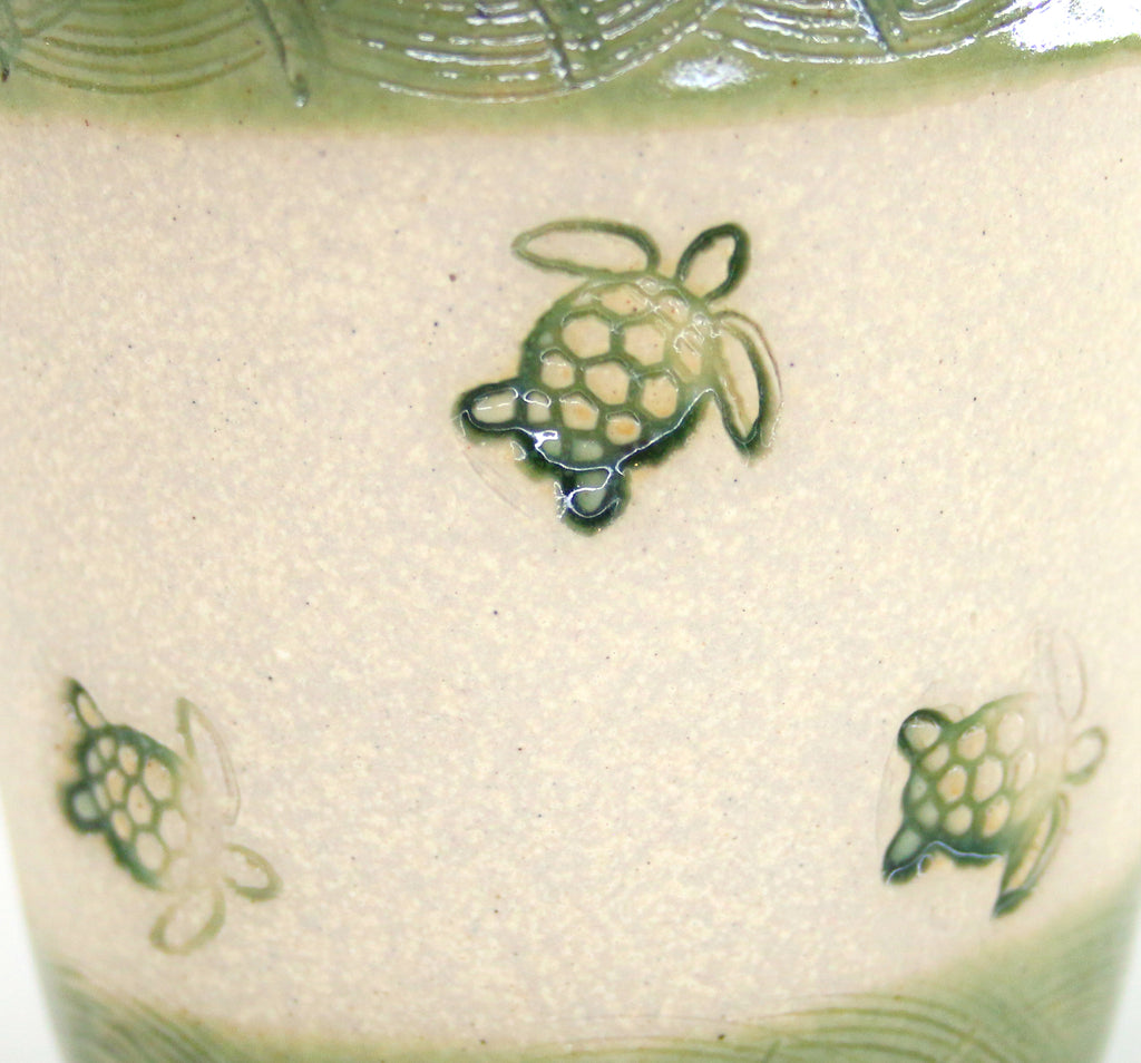 Coastal themed pottery, high fired stoneware mug with a hand etched design of sea turtles. Close up of artwork