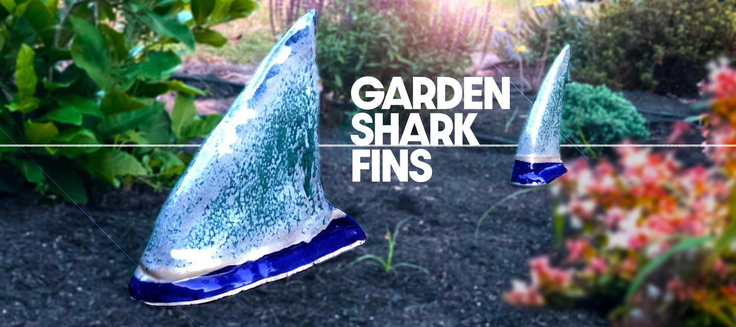 A pair of beautiful stoneware shark fins for your garden to scare away the bunnies!